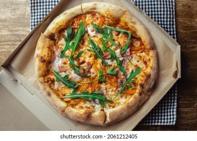 Close-up Of Pizza With Bacon In A Disposable Dish. Top View Of Takeaway Food In A Fast Food Cafe. On Photo - Mozzarella Cheese, Tomatoes, And Red Basil. The Classic Recipe. Food For Family And Friends