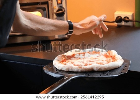 Similar – Image, Stock Photo Anonymous chef preparing pizza in a pizzeria
