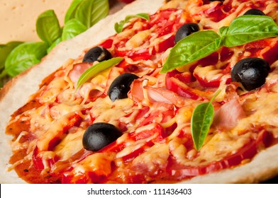 Closeup Of Pizza With Tomatoes, Cheese, Black Olives And Peppers