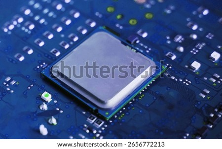 Close-up of a plain silver CPU chip mounted on a clean blue circuit board, symbolizing digital simplicity, core processing power, and electronic engineering.