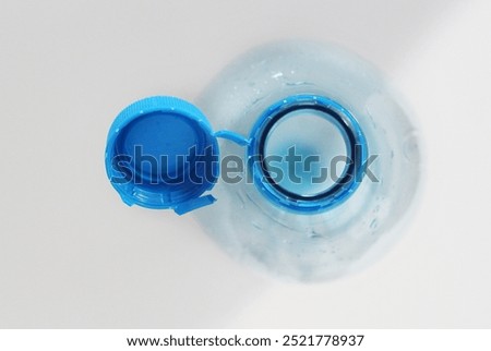 Close-up of a plastic bottle cap permanently attached to the bottle in accordance with European Union law