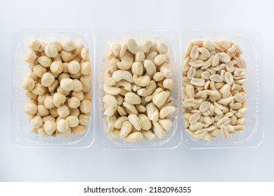 Close-up Plastic Box With Various Varieties Of Nuts On A White Background. 