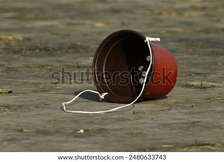 Closeup of a Plastic container lying at the sea coast after Hiya biya celebration