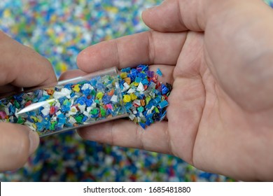 Close-up of plastic polymer granules. hand hold Polymer pellets. polymer plastic. compound polymer.