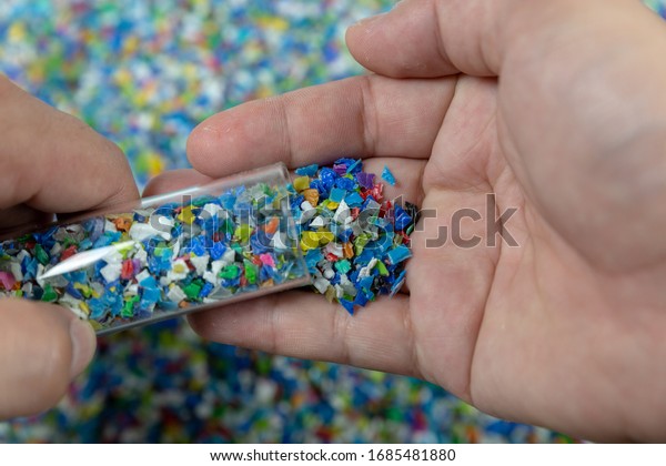 Close-up of plastic polymer\
granules. hand hold Polymer pellets. polymer plastic. compound\
polymer.