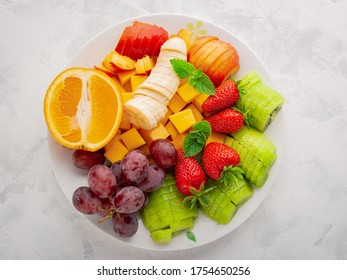 Closeup Plate With Assorted Fruits And Berries For Fruit Salad Top View.