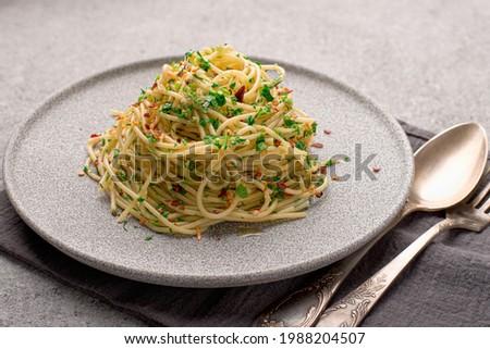 Close-up plate with cooked traditional Italian spaghetti aglio served