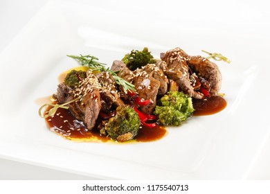 Closeup Plate Of Delicious Beef Meat With Brocolli, Pepper And Sauce Isolated At White Background.