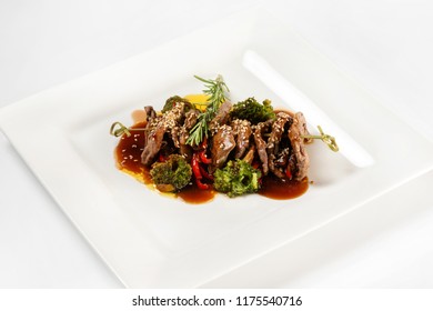 Closeup Plate Of Delicious Beef Meat With Brocolli, Pepper And Sauce Isolated At White Background.