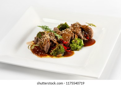 Closeup Plate Of Delicious Beef Meat With Brocolli, Pepper And Sauce Isolated At White Background.