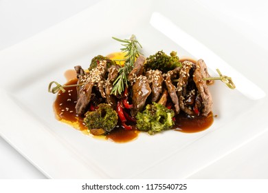 Closeup Plate Of Delicious Beef Meat With Brocolli, Pepper And Sauce Isolated At White Background.