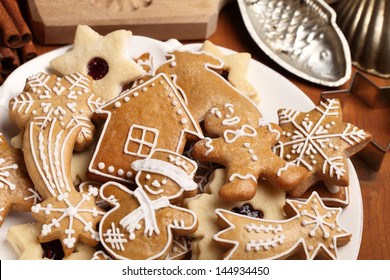 Close-up Of Plate With Gingerbread Cookies And Vintage Cookie Cutters.