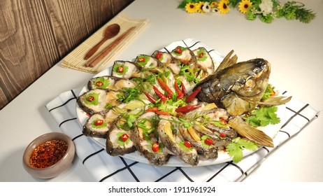 Close-up Of A Plate Of Steamed Fish Garnished With Red Chili On The Table, Top View, Homemade Food