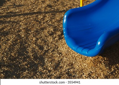 Close-up Of Playground Slide And Wood Chips