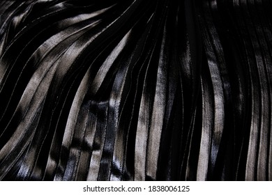 Close-Up Pleated And Silver Foil Printed Black Fabric. Material Textile And Leather.