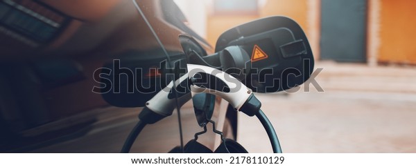 Close-up of plug for electric car on charging\
station. Panoramic banner\
view.