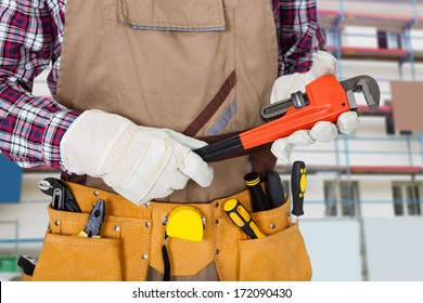 Close-up Of Plumber Holding Monkey Spanner With Worktool In Tool Bag