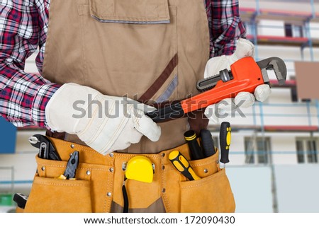 Close-up Of Plumber Holding Monkey Spanner With Worktool In Tool Bag