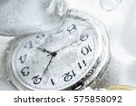 Closeup of pocket watch under frozen water background with ice