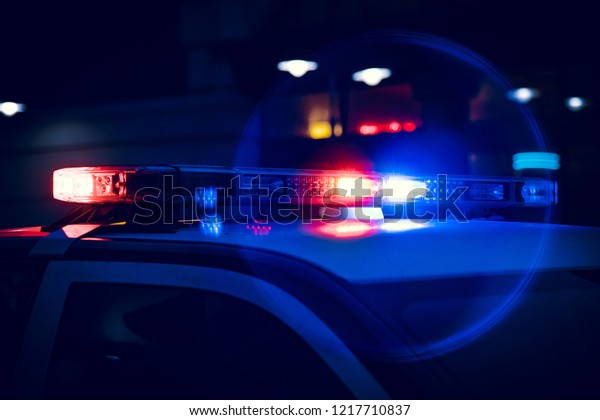 Closeup of\
Police Lights on Dark Street at\
Night