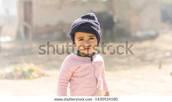 closeup of a poor staring hungry\
orphan boy in a refugee camp with sad expression on his face and\
his face and clothes are dirty and his eyes are full of\
pain