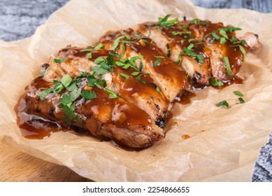 Closeup of pork ribs grilled with BBQ sauce and caramelized in honey.Tasty snack to beer on a wooden Board - Shutterstock ID 2254866655