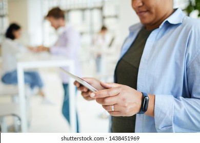 Close-up Of Portly Black Woman With Fitness Tracker Using Digital Tablet While Surfing Net, Copy Space