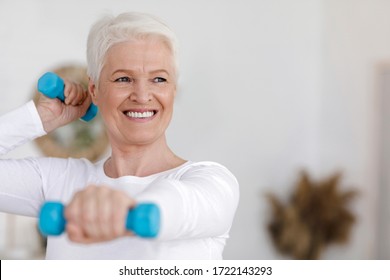 Closeup Portrait Of Active Elderly Woman Doing Exercises With Dumbbells At Home, Copy Space