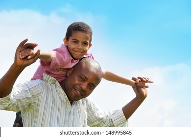 Close-up portrait African American father and the sun playing together