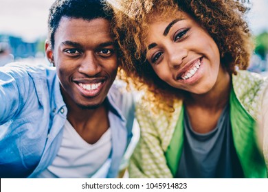 Close-up portrait of african american hipster friends smiling with healthy white teeth satisfied with dentist and whitening,happy dark skinned sister and bother exciting with leisure looking at camera