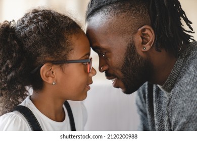 Closeup portrait of african-american father and small little young preteen daughter hugging embracing sharing love and care. Dad`s protection. Fatherhood. Happy Father`s day!
