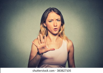 Closeup Portrait Of Angry Annoyed Woman Raising Hand Up To Say No Stop Right There Isolated On Gray Background. Negative Human Emotion Facial Expression