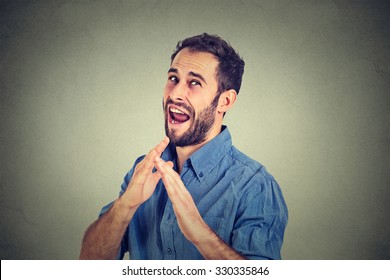Closeup portrait of angry mad, furious man raising hands in the air attack with karate chop isolated gray wall background. Negative emotion facial expression feeling body language, signs and symbols