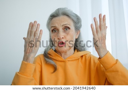 Closeup portrait of angry upset senior mature woman talking with someone and looking at the camera. Negative emotion, facial expression, scandal