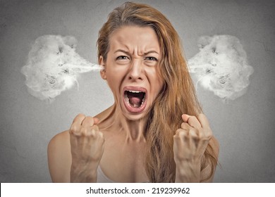 Closeup portrait angry young woman blowing steam coming out of ears, having nervous atomic breakdown, screaming isolated grey wall background. Negative human emotion facial expression feeling attitude