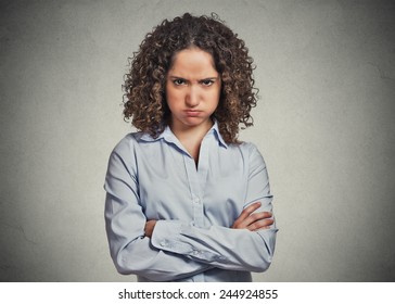 Closeup portrait of angry young woman puffing cheeks isolated on grey wall background. Negative human emotions face expressions feelings perception 