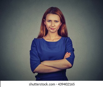 Closeup portrait of angry young woman, being skeptical, displeased isolated on gray wall background. Negative human emotions facial expression feelings attitude