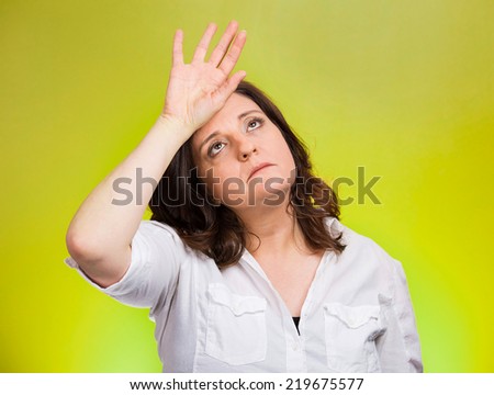 Closeup portrait annoyed tired middle aged woman placing back hand on forehead, tragedy of it all, woe is me, exaggerating isolated green background. Negative emotion, facial expression, perception