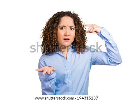 Closeup portrait annoyed, unhappy, displeased woman gesturing her finger against temple, are you crazy? asking think carefully, isolated white background. Negative emotion, facial expression, reaction