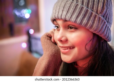 Close-up Portrait Of Asian, Indian Beautiful, Serene Young Woman Wearing A Winter Cap, Looking Away And Thinking Deeply With A Toothy Smile. 