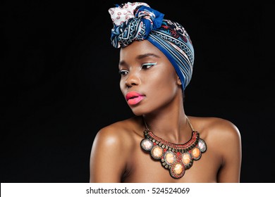 Close-up portrait of an attractive afro american woman looking away isolated on the black background