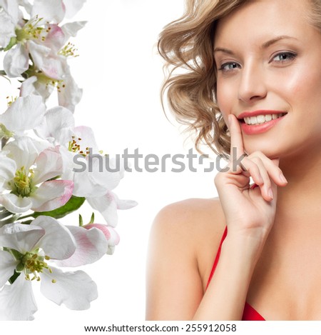 closeup portrait of attractive  caucasian smiling woman blond isolated on white studio shot lips toothy smile face hair head and shoulders looking at camera blue eyes tooth spring flowers