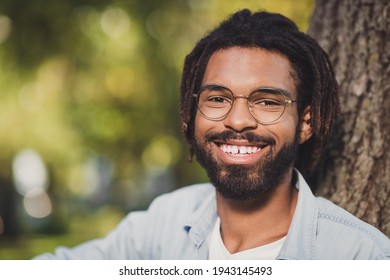 Close-up portrait of attractive cheerful guy spending time in green forest wood sunny day outside outdoor - Powered by Shutterstock