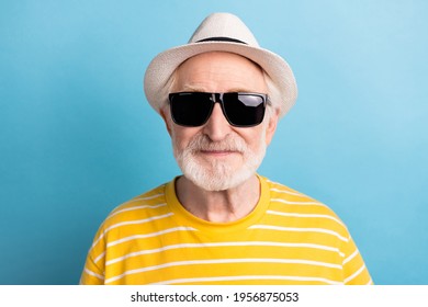 Close-up portrait of attractive cool man wearing black sun specs isolated over bright blue color background - Powered by Shutterstock