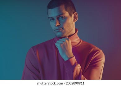 Close-up Portrait Of Attractive Male Model. Retro Wave Portrait Of A Young Man At Studio. High Fashion Male Model In Colorful Bright Neon Lights