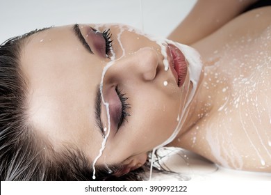 Close-up Portrait Of Attractive Young Kazakh Woman With Closed Eyes And Splashes Of Milk On Her Face