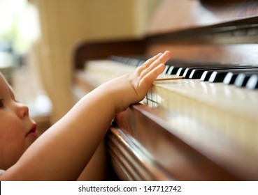 closeup portrait of a baby playing the piano