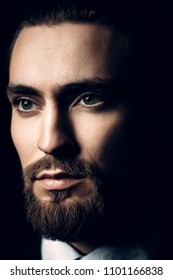 Close-up portrait of a bearded handsome young man in elegant clothes. Male beauty, fashion. Hair styling, barbershop. 