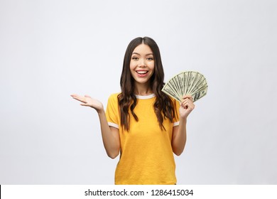 Closeup Portrait Of Beautiful Asian Woman Holding Money Isolated On White Background. Asian Girl Counting Her Salary Dollar Note. Success Wealth Financial Business Cashflow Currency Payment Concept