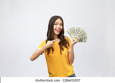 Closeup Portrait Of Beautiful Asian Woman Holding Money Isolated On White Background. Asian Girl Counting Her Salary Dollar Note. Success Wealth Financial Business Cashflow Currency Payment Concept